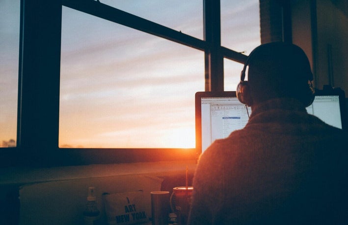 Employee working at a computer at sunset