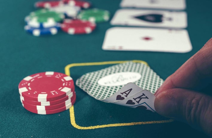 a card player peeks at their hand
