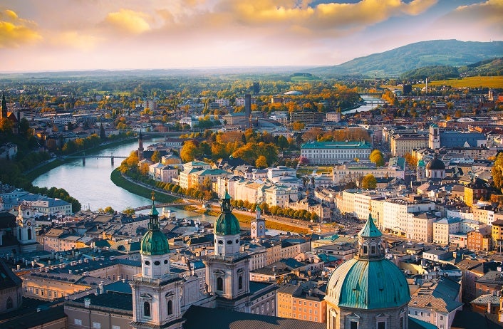 Beautiful of Aerial panoramic view in a Autumn season at a historic city of Salzburg with Salzach river in beautiful golden evening light sky and colorful of autumn at sunset, Salzburger Land, Austria