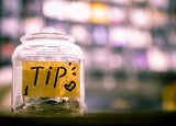 Tip jar containing cash