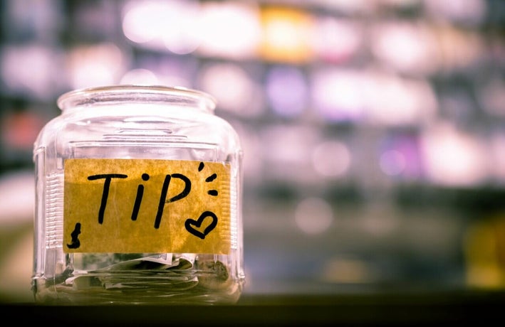Tip jar containing cash