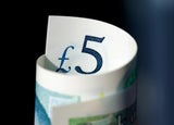 A rolled up £5 note