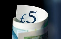 A rolled up £5 note