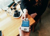 Customer paying by card at a cafe
