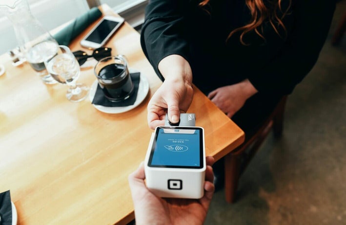 Customer paying by card at a cafe