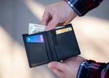 Person taking cash out of a wallet
