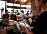 Restaurant staff member preparing a bill