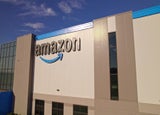 Toronto, Ontario, Canada - September 11, 2022: Amazon warehouse building headquarter and close-up logo of the company at golden hour evening. Technology company developed international e-commerce.