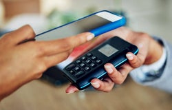 Person using a card machine to accept a mobile payment
