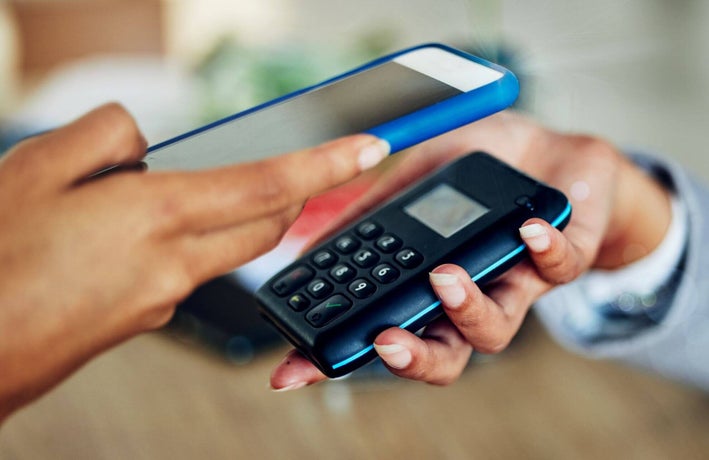 Person using a card machine to accept a mobile payment