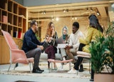 Company team sitting together in an open-plan office space.