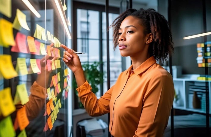 Business owner making notes and revising goals and structure