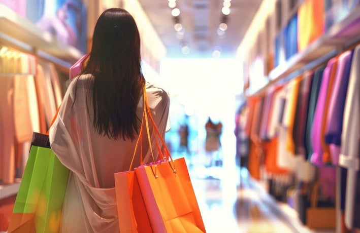Customer in a clothes shop carrying bags