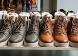 a line up of identical looking black and brown boots