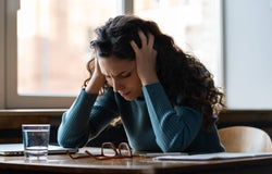 a woman struggling with stress at her desk