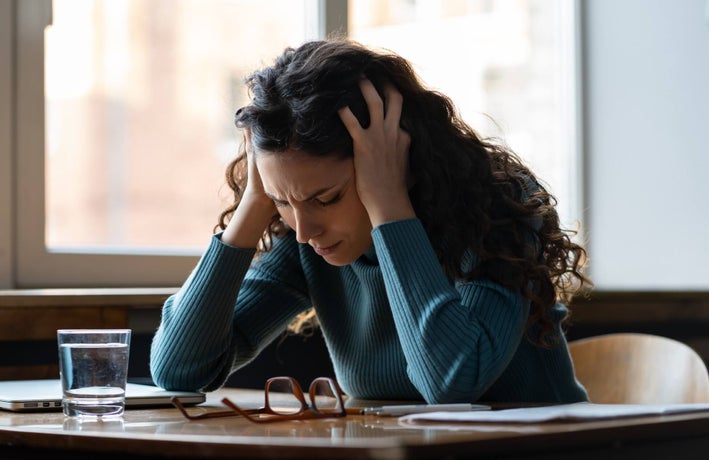 a woman struggling with stress at her desk