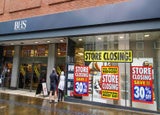 The front of a BHS store with closing down signs across the windows.