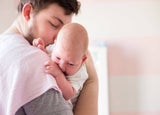 Man holding newborn baby