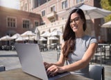 Woman working at a cafe outdoors abroad