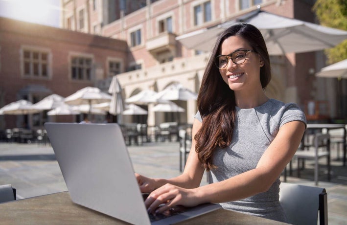 Woman working at a cafe outdoors abroad