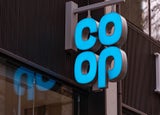 Sign of the co-op hanging outside a high street store.
