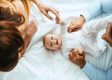 Mother and father playing with their baby