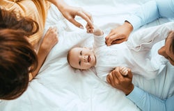 Mother and father playing with their baby