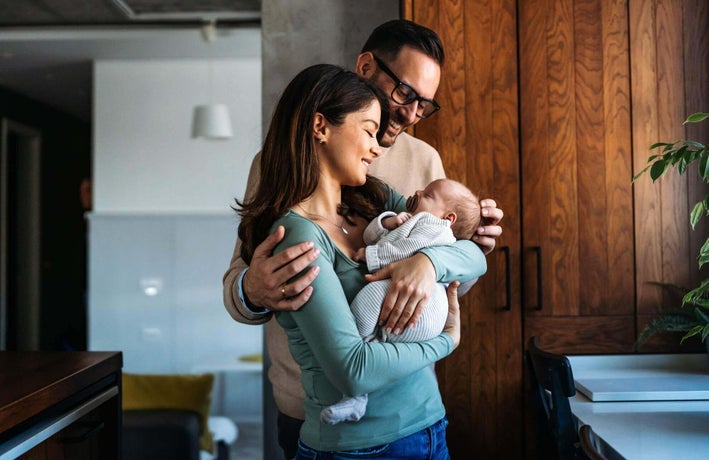 Mother and father holding a baby