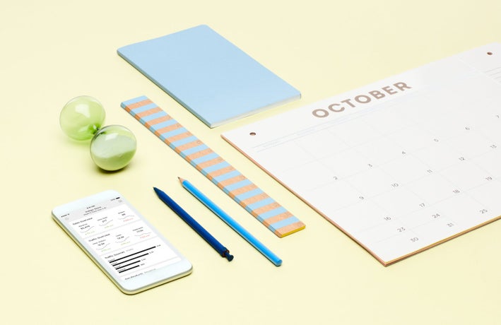 Yellow background with calendar, stationary supplies, and a phone showing online sales information