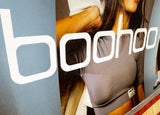 Close up of a Boohoo ad displayed within the London underground.