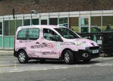 Pink PrettyLittleThing van on road