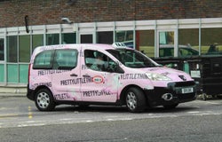 Pink PrettyLittleThing van on road
